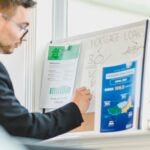 Real estate investor reviewing mortgage loan charts and cash flow analysis for buying discounted mortgage notes