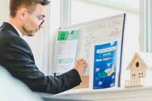 Real estate investor reviewing mortgage loan charts and cash flow analysis for buying discounted mortgage notes